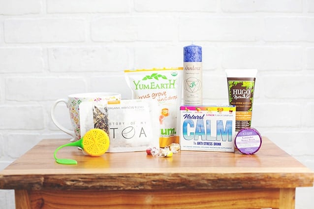 a calmbox with an inspiration card set, a plush bear, a spray, candy, and other items