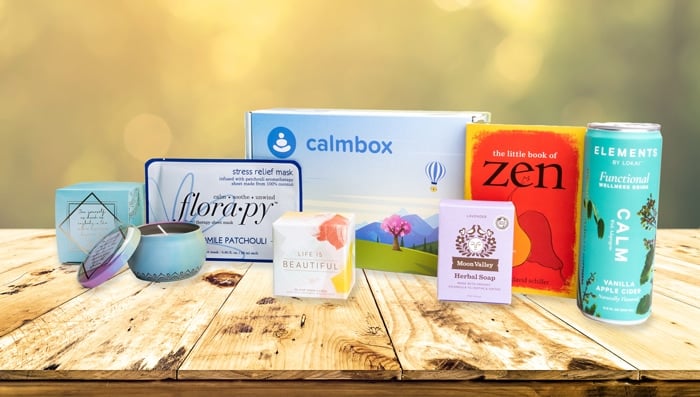 an example calmbox, with mints, tea, socks, a mala bracelet, an indulgence bar, and bath salts